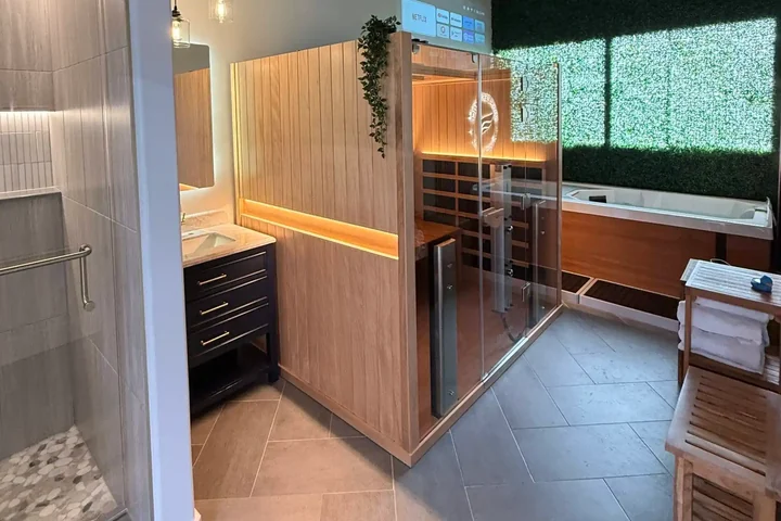 The recovery suite at Revival Performance Physical Therapy: infrared sauna, cold plunge and the Revival wing etched on the glass