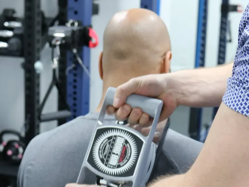 Physical therapist testing a patient's overhead reach and rotator cuff strength