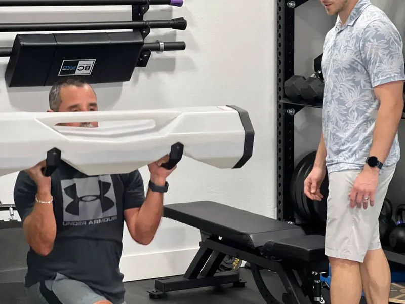 Patient performing progressive strength training under supervision