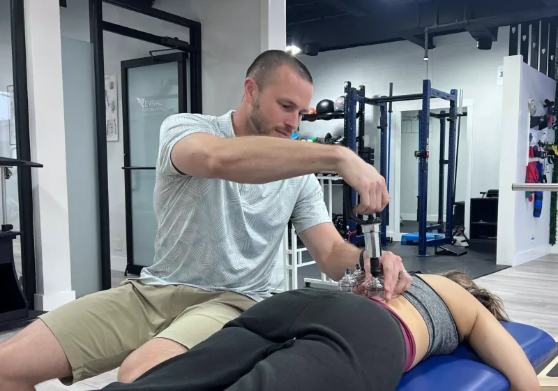 Cupping applied along a patient&rsquo;s upper back with suction cups in place
