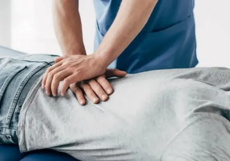 Doctor of Physical Therapy performing hands-on joint mobilization on a patient&rsquo;s spine