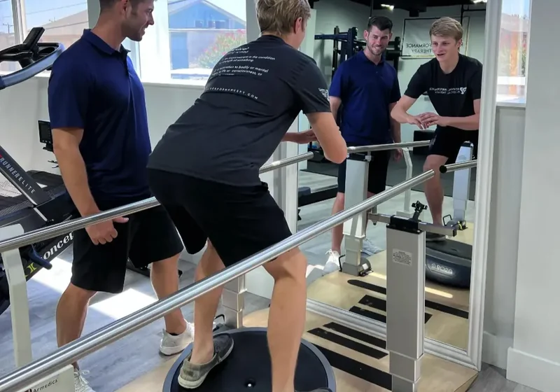 One-on-one strength training session on the gym floor of a physical therapy clinic