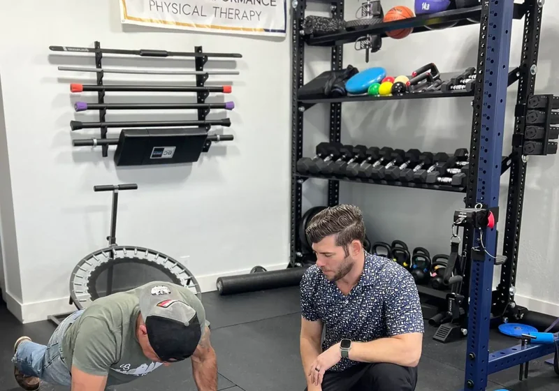 Doctor of Physical Therapy guiding a patient through a one-on-one exercise session