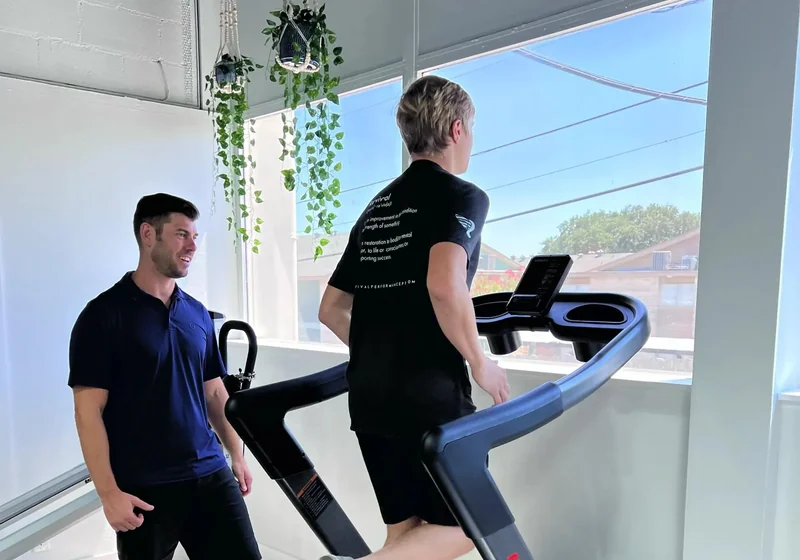 Doctor of Physical Therapy assessing a runner&rsquo;s stride during a running evaluation